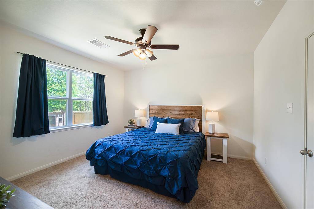 Step into the primary bedroom and you will be pleased by its comfortable size and large windows with a wonderful view to the backyard.