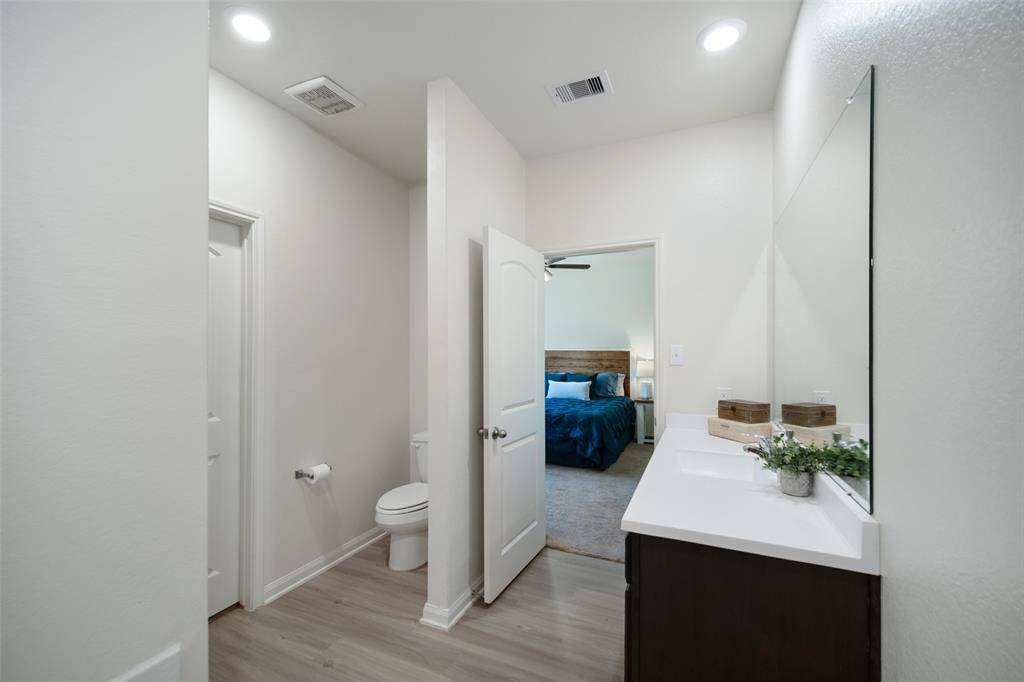 The long vanity with sink has plenty of counter and cabinet space for sharing.  The large closet is at left.