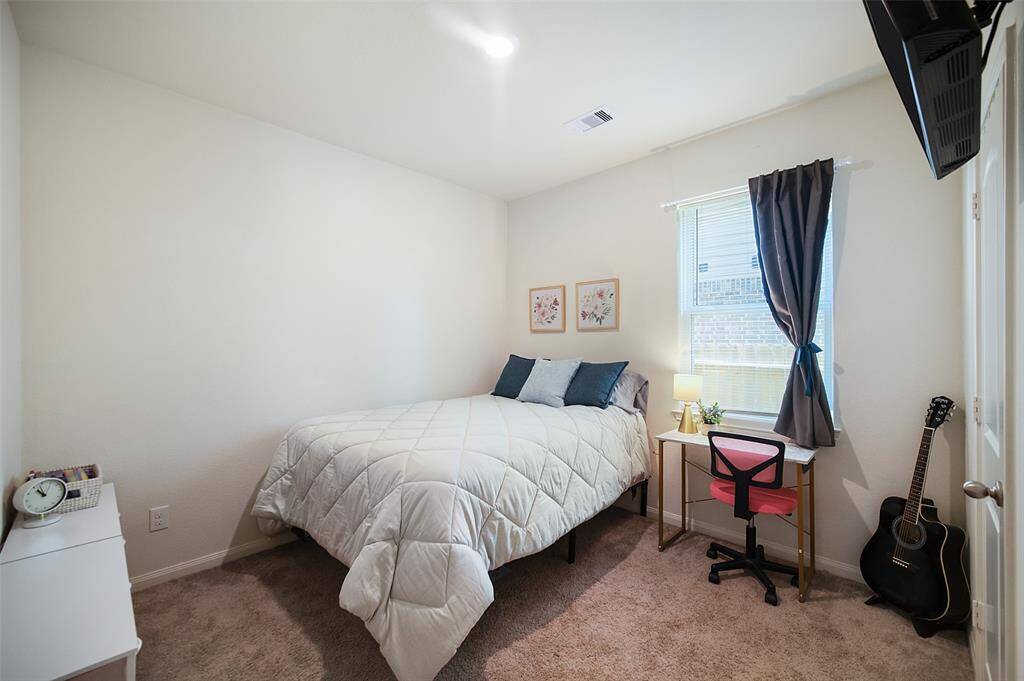 Bedroom 2 of 3 holds a double bed with room to spare.