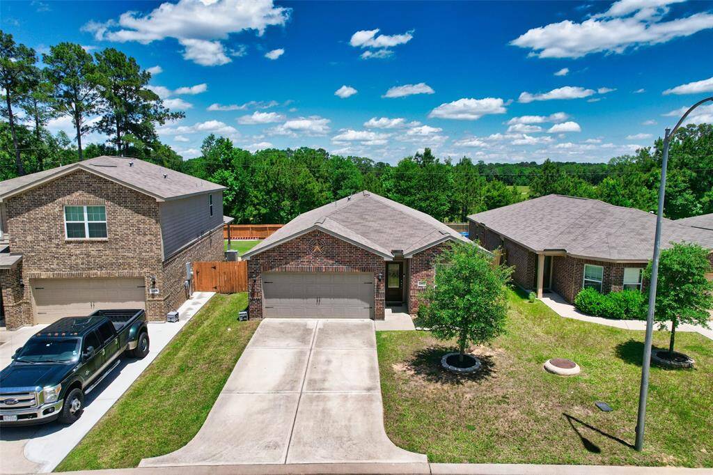 The home is inviting, thanks to a double-wide driveway for extra parking and a shaded entryway.