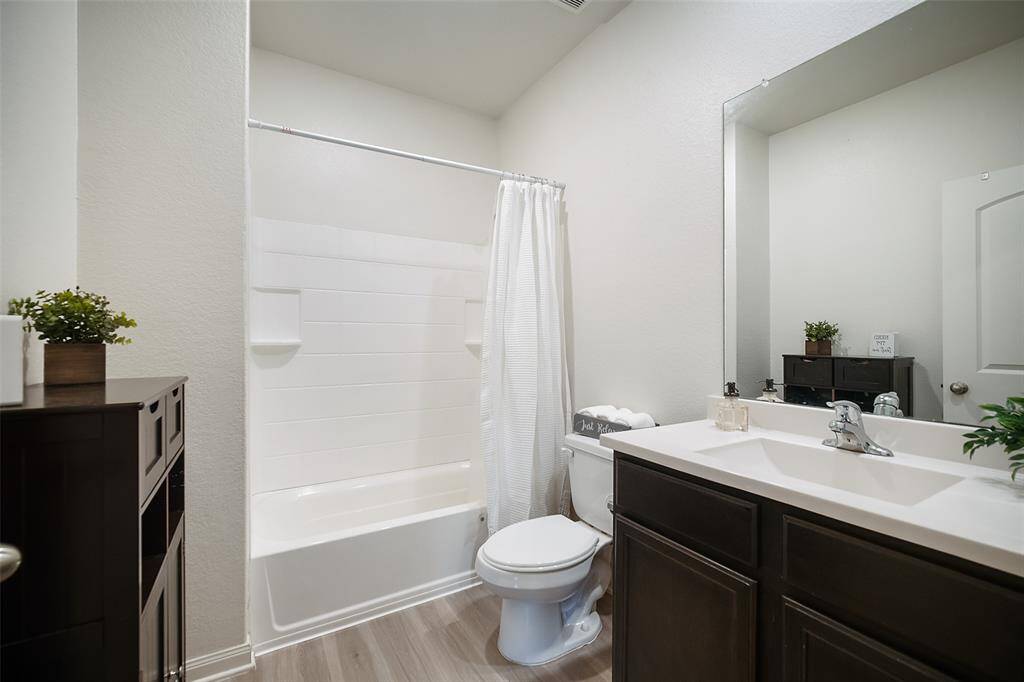 This pristine bathroom is located on the hallway with Bedrooms 2 and 3.