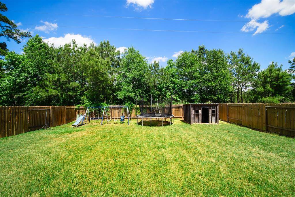 This view of the backyard shows there is room for a garden, a play fort, a trampoline, or all three!  While the sellers plan to take the play equipment, the open shed may stay if desired.