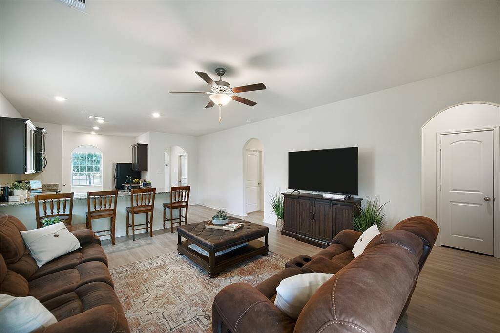 From every angle, this family room is both beautiful and practical. The arched hallways lead to the secondary bedrooms on left and the primary bedroom on right.