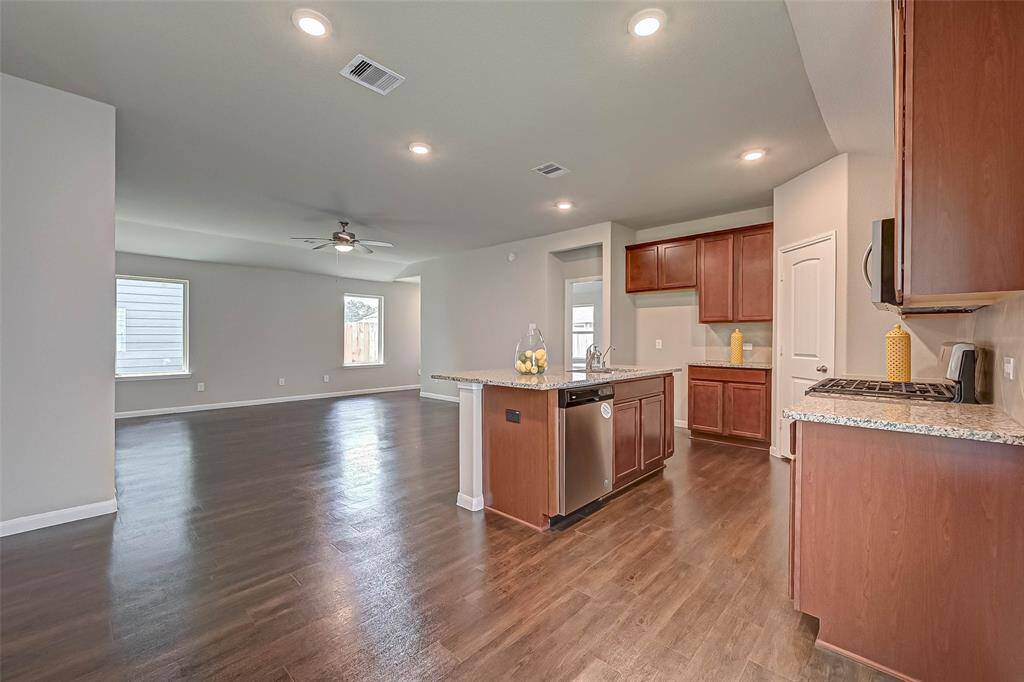 Open-concept layout creates a natural flow between the expansive living room, dining area, and kitchen