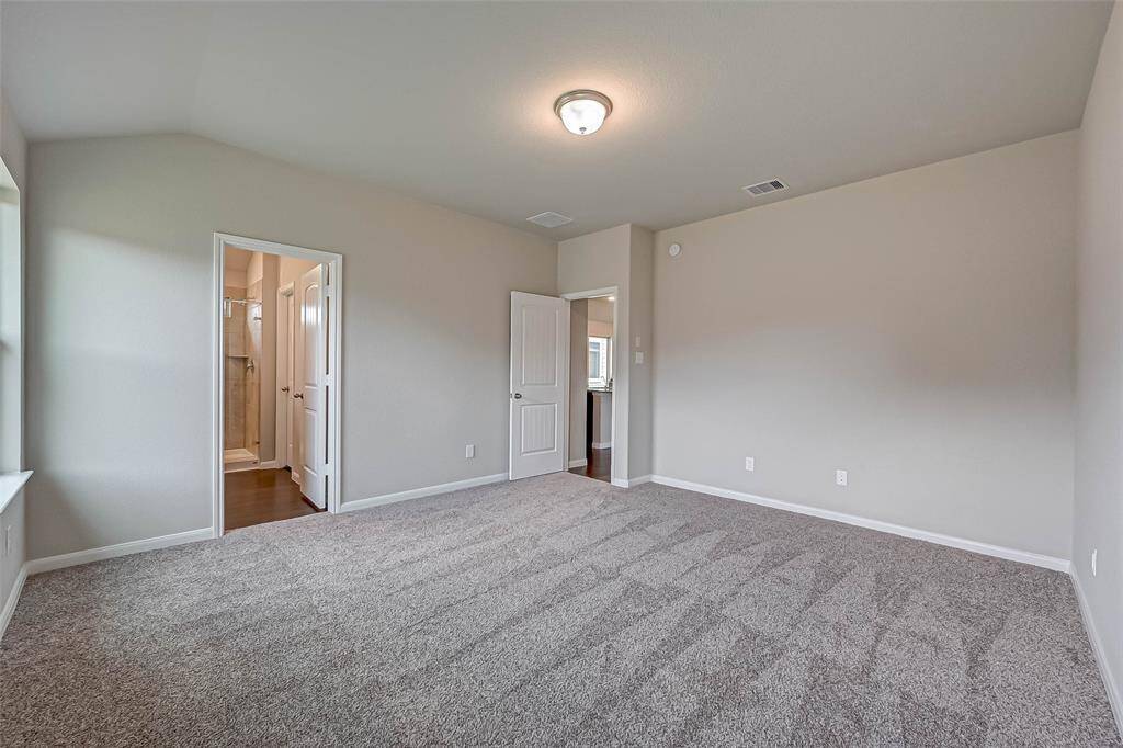 The primary bedroom features a walk-in closet and a private ensuite bathroom