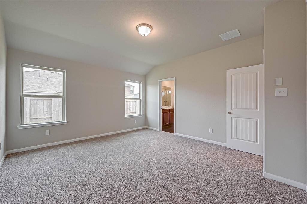 Retreat to the spacious owner’s suite with a sleek vanity and walk-in shower