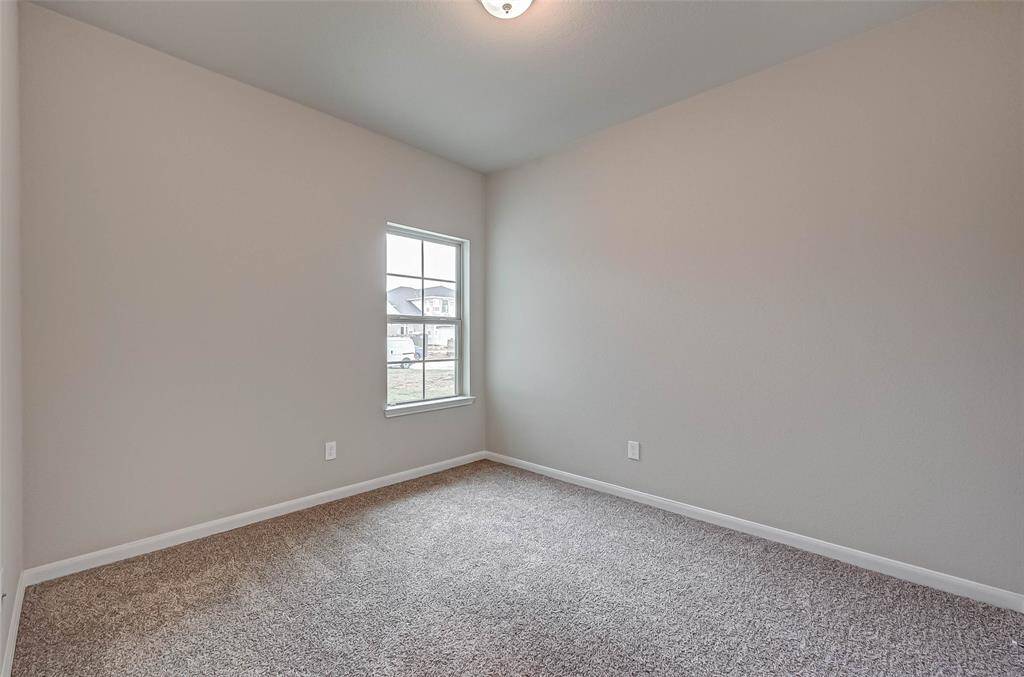 The secondary bedroom is spacious and filled with natural light.