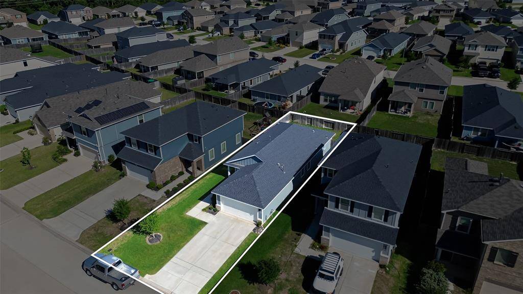 An extended driveway offers ample parking for guests or family.
