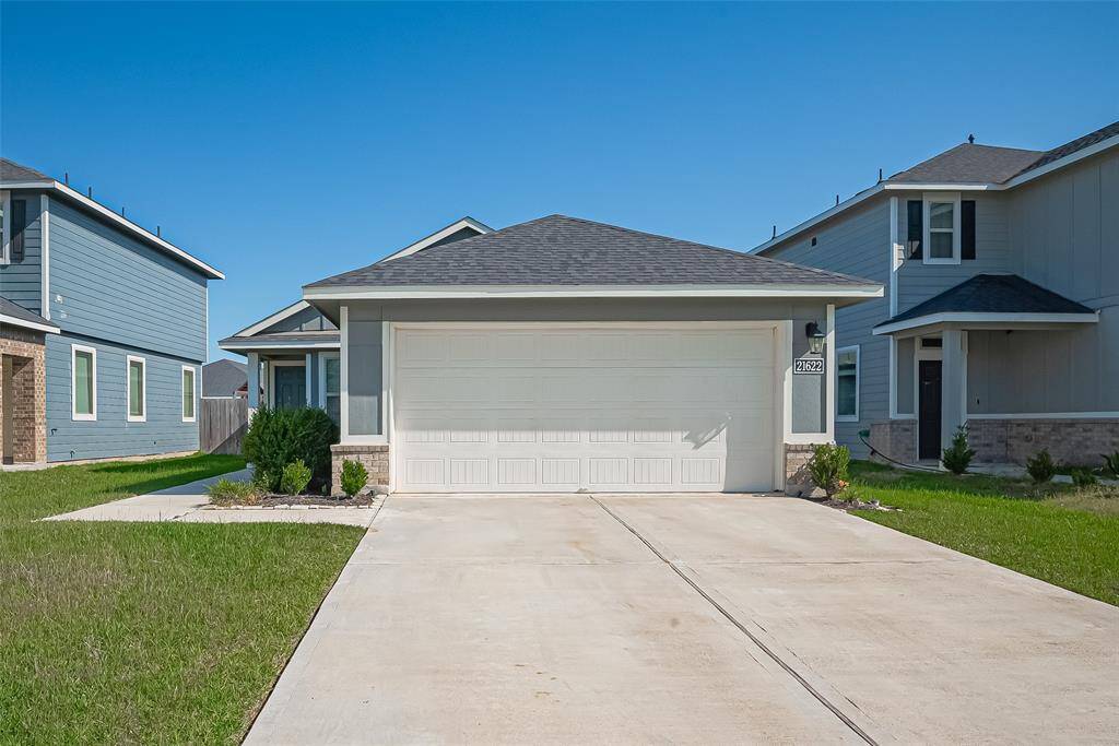 An extended driveway offers ample parking for guests or family.