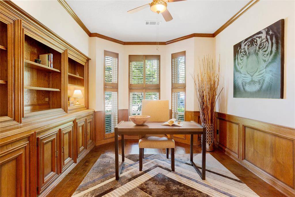 Need a private escape to work? This cozy home office/study is a great place! With custom wood paneling, built in bookshelf and cabinets and luxury plantation shutters.