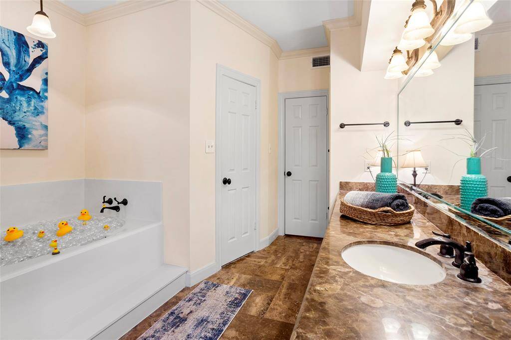 Private toilet and separate shower, soaking tub, and mirror border.