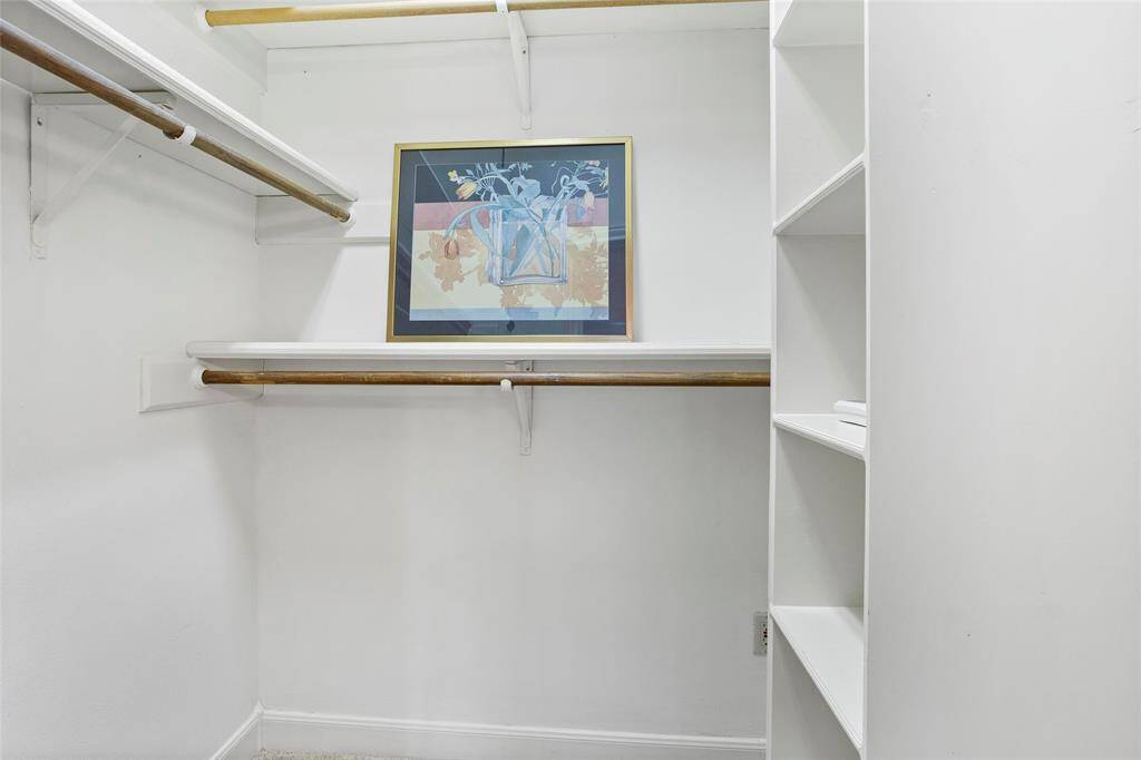 Primary walk in closet #2...both with built in shelves.