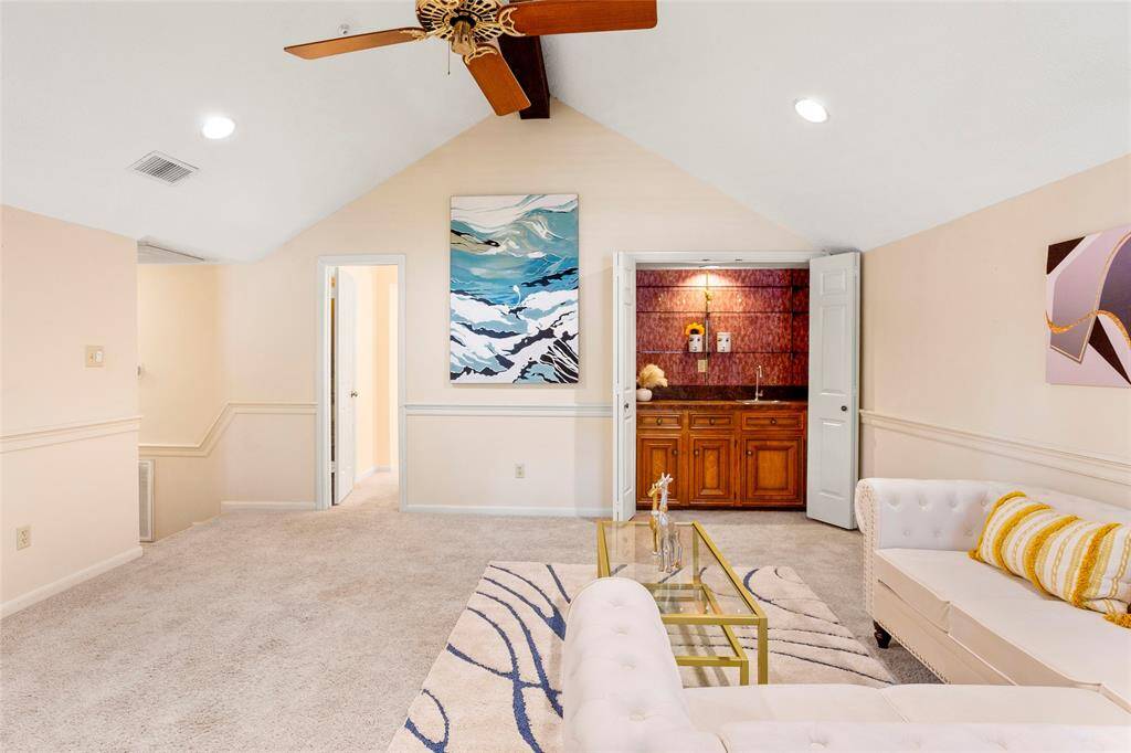 This flex-space also has wet bar with bi-fold doors, sink, wood cabinets and glass shelving. Gameroom shares bathroom entry with Bedroom #2.