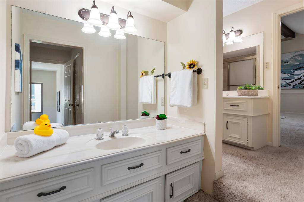 This bathroom is truly unique! Shareable entry with Bedroom #2 and the game room. It has 2 separate countertops each with a sink, mirror, vanity lighting...