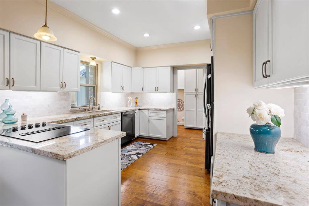 Kitchen is spacious with custom cabinets, granite countertops, new stainless steel appliances, new floors...
