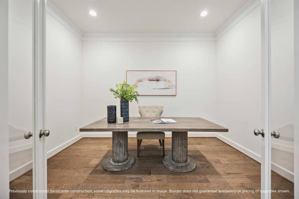 Need a quiet space to work or create? This glass-doored room near the entry is ideal for a study, Zoom room, or library—with just enough privacy to stay focused.