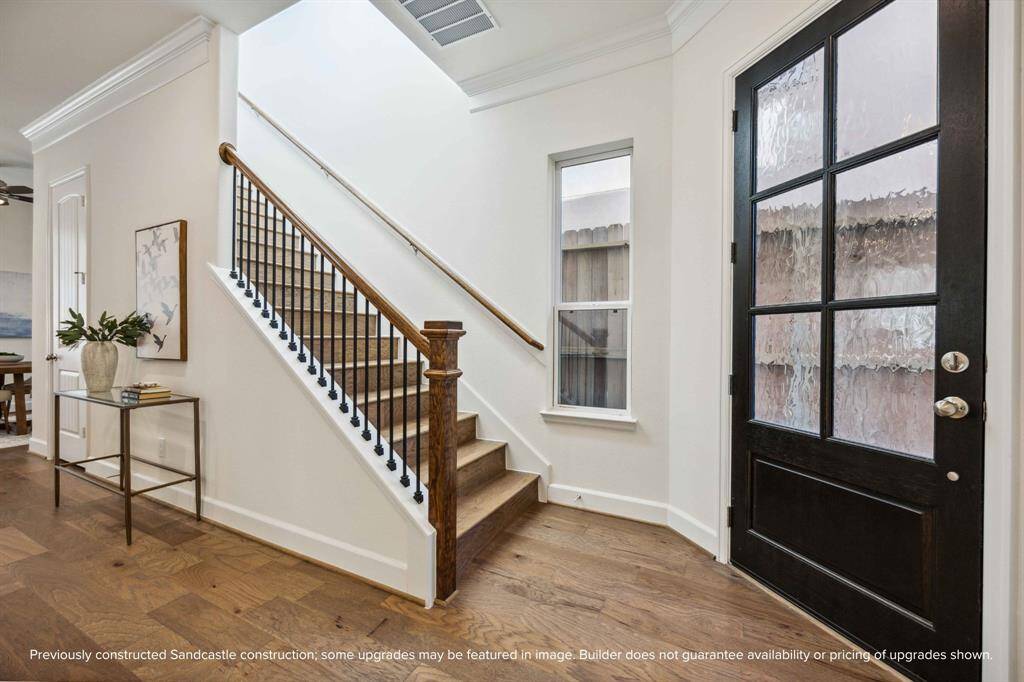Hello, modern welcome moment! This back entry sets the tone with warm wood tones, a statement staircase, and sunlight that practically greets you at the door.
