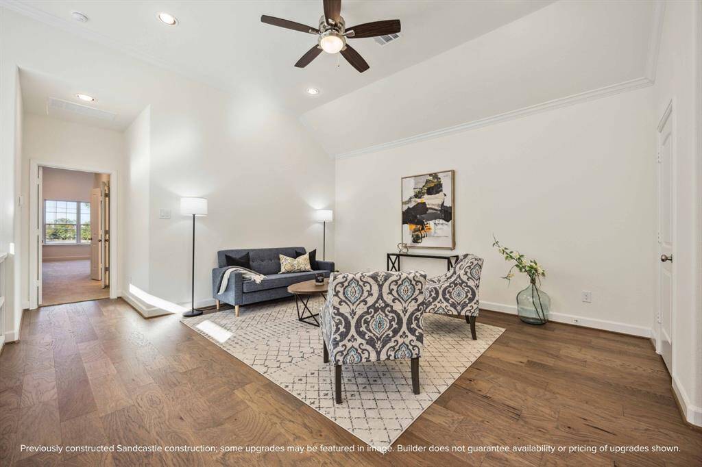 Perched at the top of the stairs, this upstairs lounge is a choose-your-own-adventure space—cozy TV den, home office, or creative corner. The vibe? Totally relaxed.
