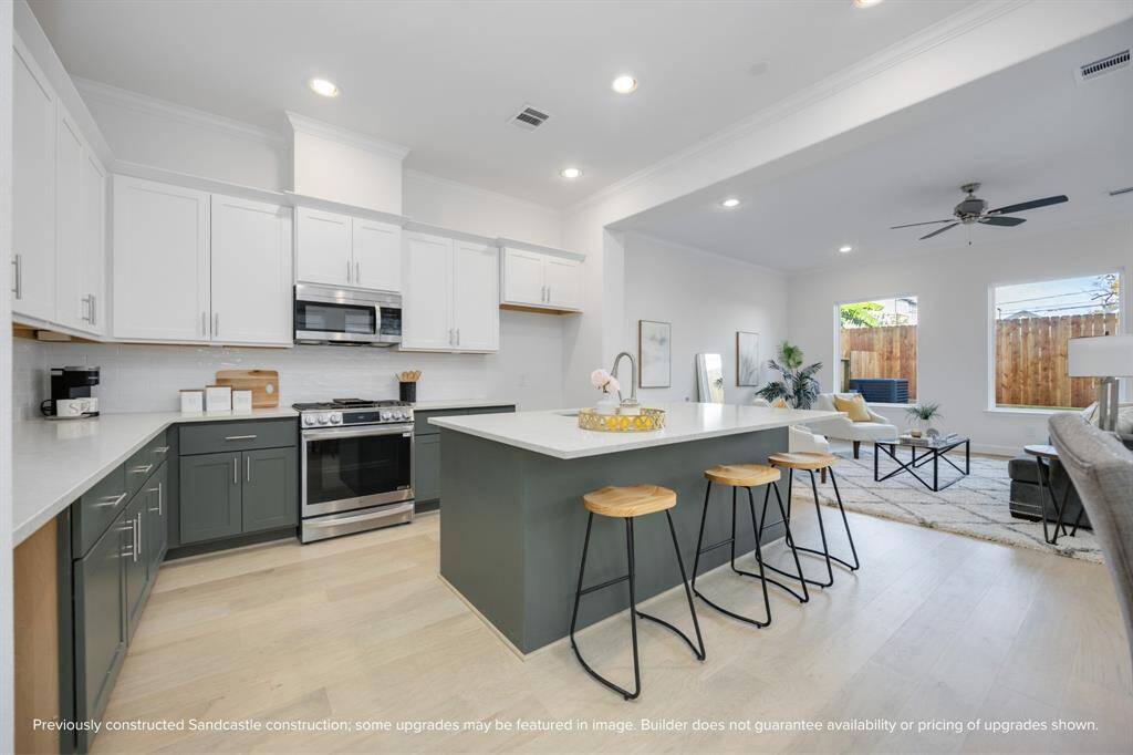 Designer Finishes Meet Everyday Function: Timeless meets trendy in this gourmet kitchen with Benedettini cabinets with soft-close drawers, quartz countertops, and custom design selections. The open layout keeps you connected to the living and dining spaces beyond.