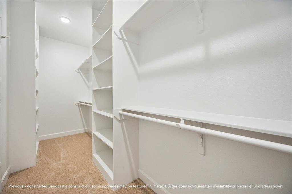 This is just one of two spacious walk-in closets in the primary suite—designed to keep your wardrobe beautifully organized and always within easy reach.