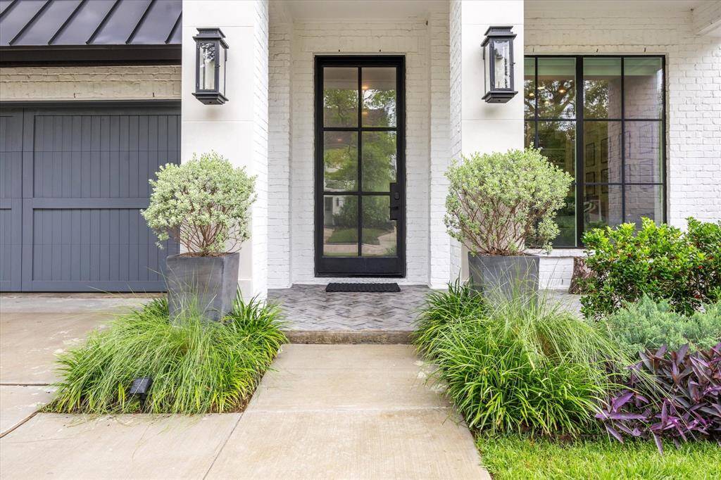Stately Iron Entrance With Privacy Glaze, Flanked by Elegant Gas Lanterns.