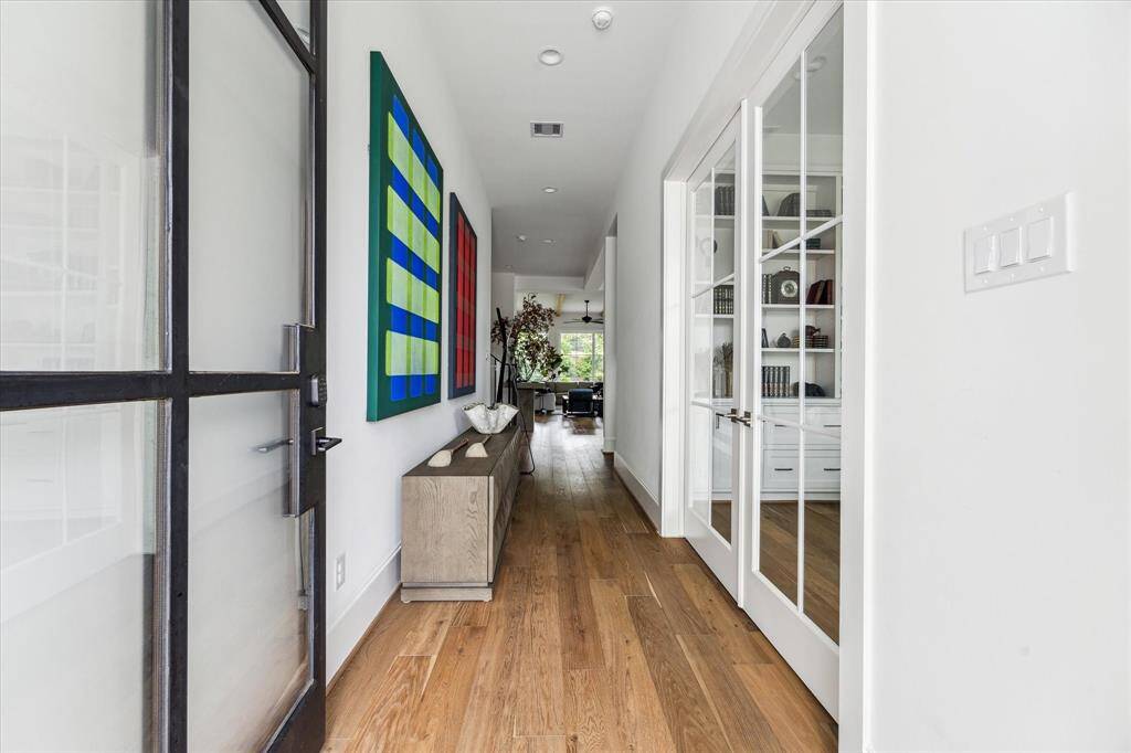 The Impressive Entryway Flows Into A Distinguished Study, Complete With Warm Wood Paneling And Expertly Crafted Built-In Cabinetry.