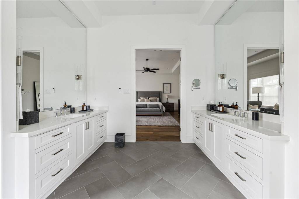 Experience luxury and functionality in the primary closet, complete with customized storage solutions and innovative pull-down wardrobe lifts.