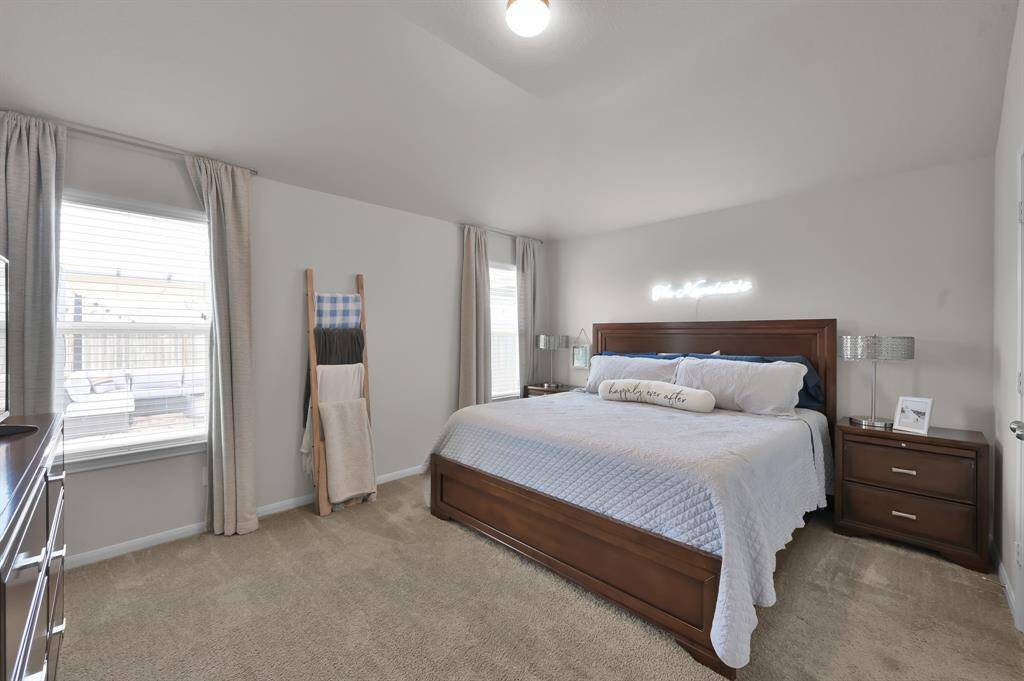 This spacious bedroom features a king size bed with plenty of extra room.