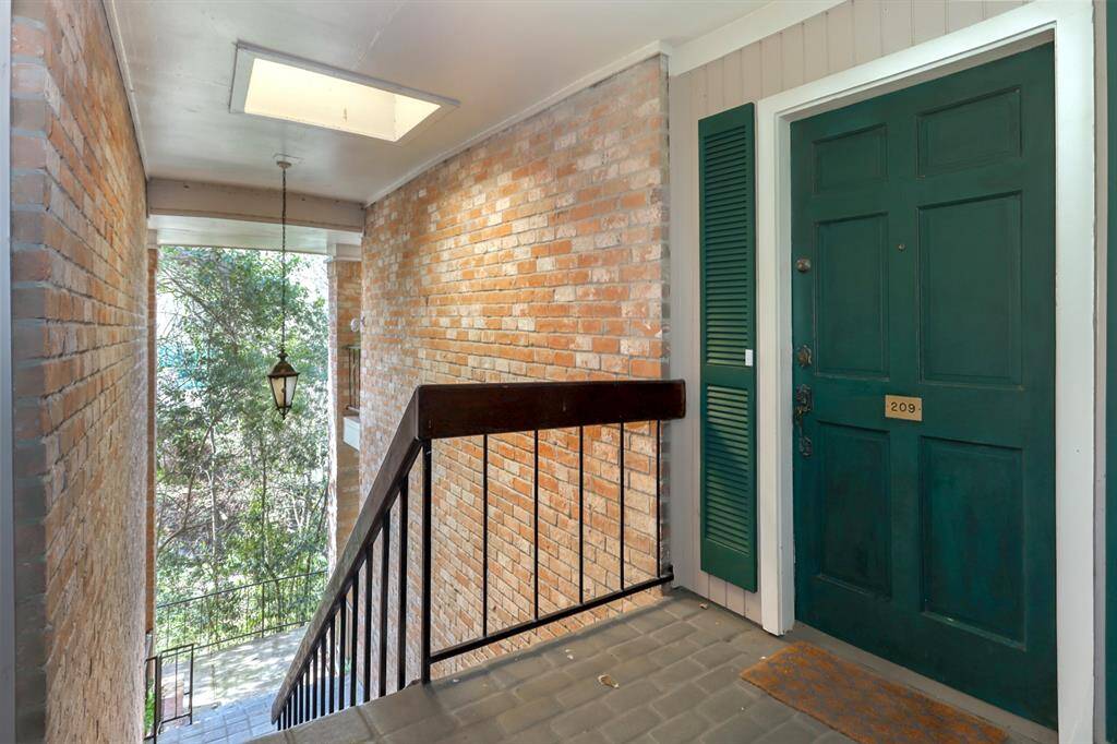 Gorgeous entrance to the condo featuring natural setting.