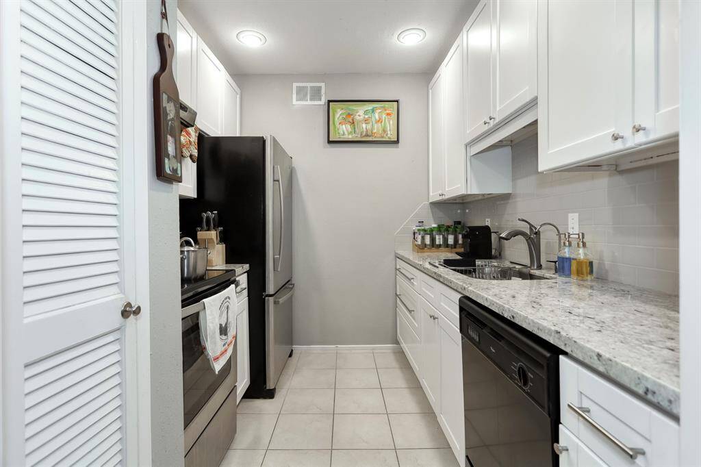 Bright and functional kitchen with white cabinetry and modern appliances.