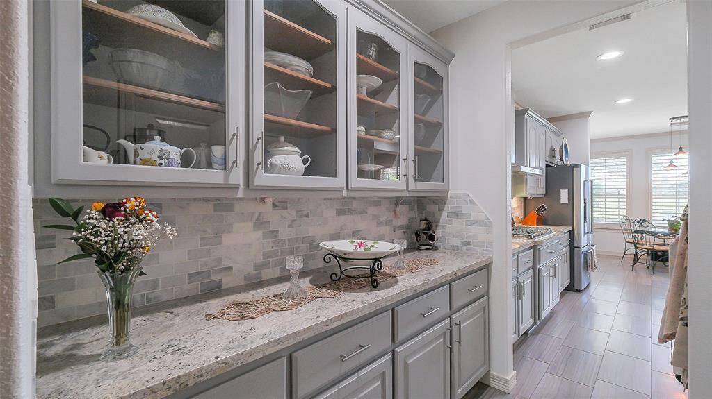 The formal dining from leads to the butler's pantry, pantry and the kitchen.  This large room will accommodate large dining sets and buffets. Custom chandelier.