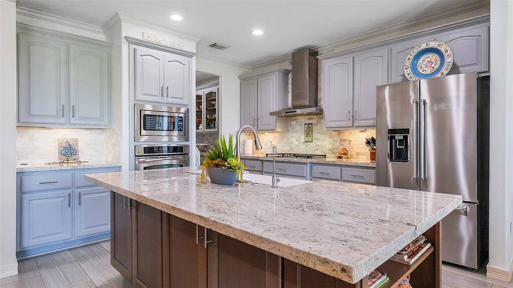 Remodeled kitchen 2021.  Light granite island with extra storage.  Wood look tile flooring.  Recessed lighting.  Wall of windows.