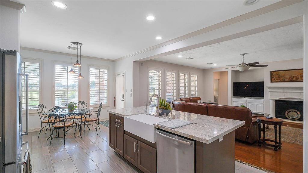 Farmhouse sink on the kitchen island.  All fixtures upgraded.   Cozy breakfast nook with a relaxing view.