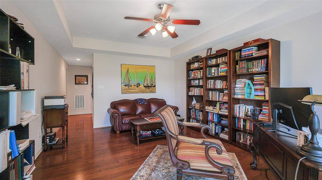 Next to the game room sits a LARGE bonus room with access to the upstairs balcony.  Trey ceiling and fan.  Wood flooring and lots of wall space.  It could be a 5th bedroom, another study, library, media room, playroom, home office,  craft room, another living room or anything you desire.