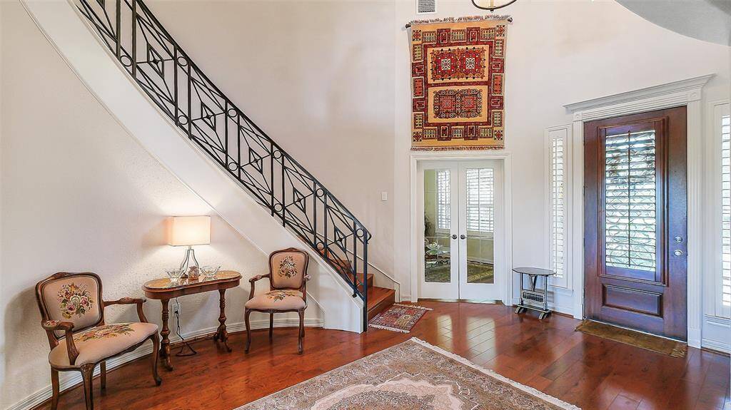 Inviting grand entry way as you open the front door.  Custom iron staircase and wood flooring.  Entire interior paint in 2023.  Formal dining room to the left and study to the right.
