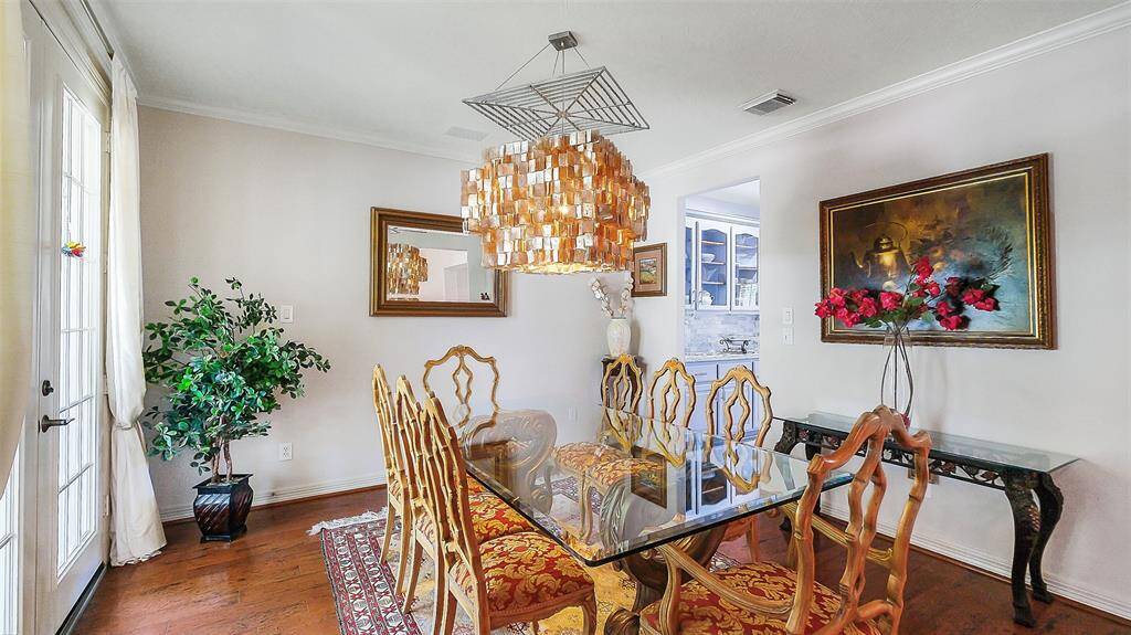 The formal dining room sits off the formal entry. French doors lead the covered front porch sitting area.