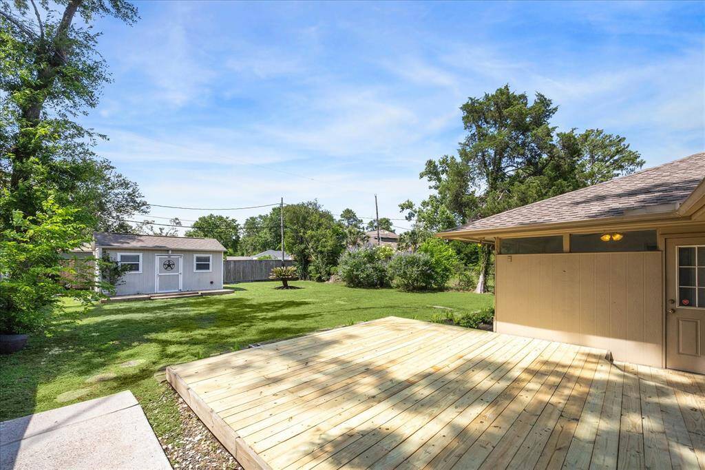 spacious backyard with. new deck and a huge workshop with power, a/c and a half bath!