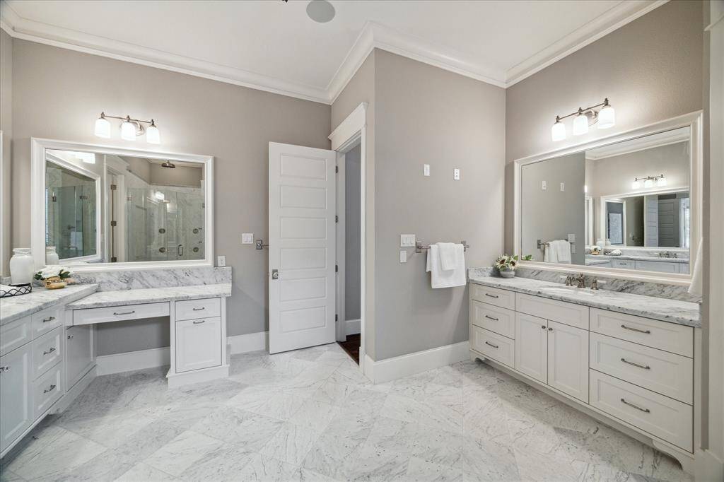 Dual sinks and vanity in the primary bathroom.