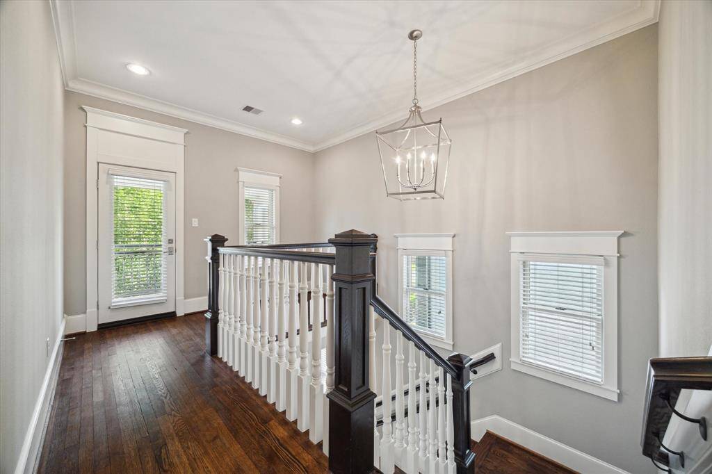The hallway upstairs is perfect for a gallery wall and room to add a library or additional office.