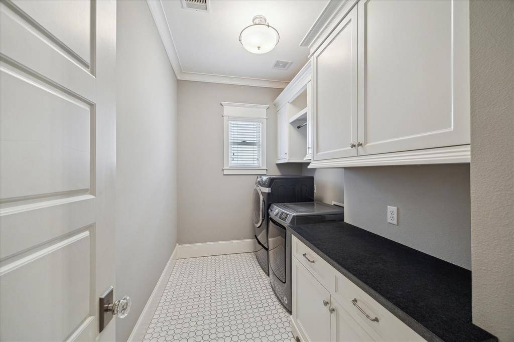 Large utility room on the second floor with tons of storage and a folding station.