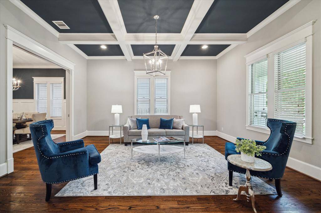 Formal living room has coffered ceilings.