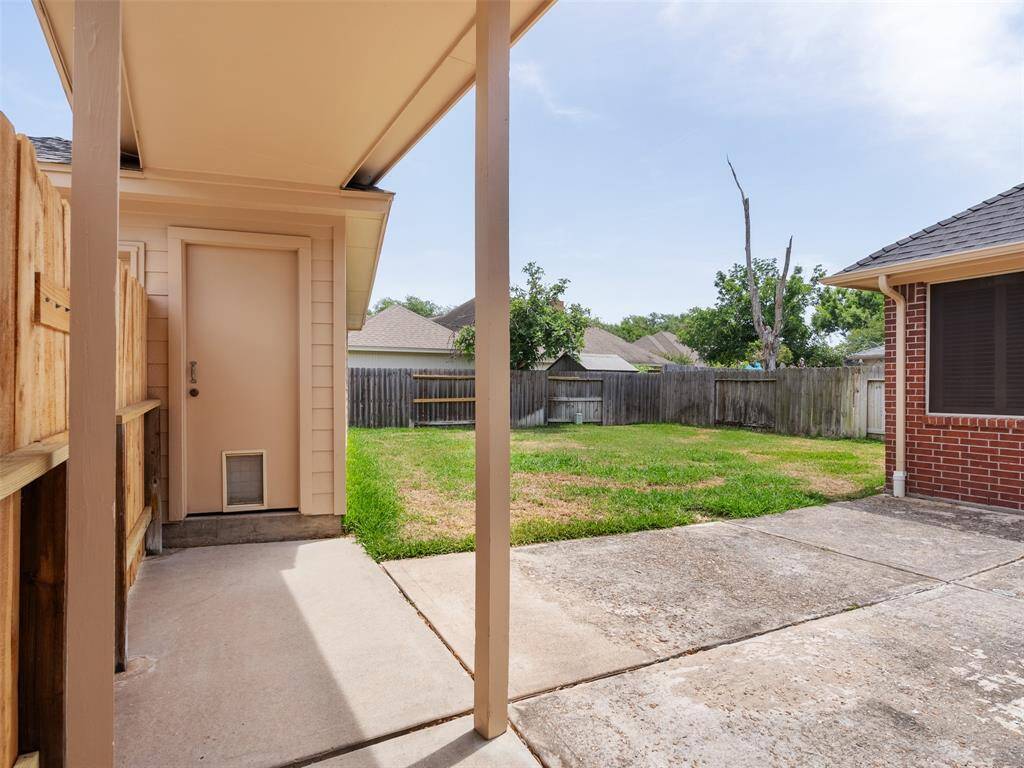 Nice view of the back yard with a large porch area.