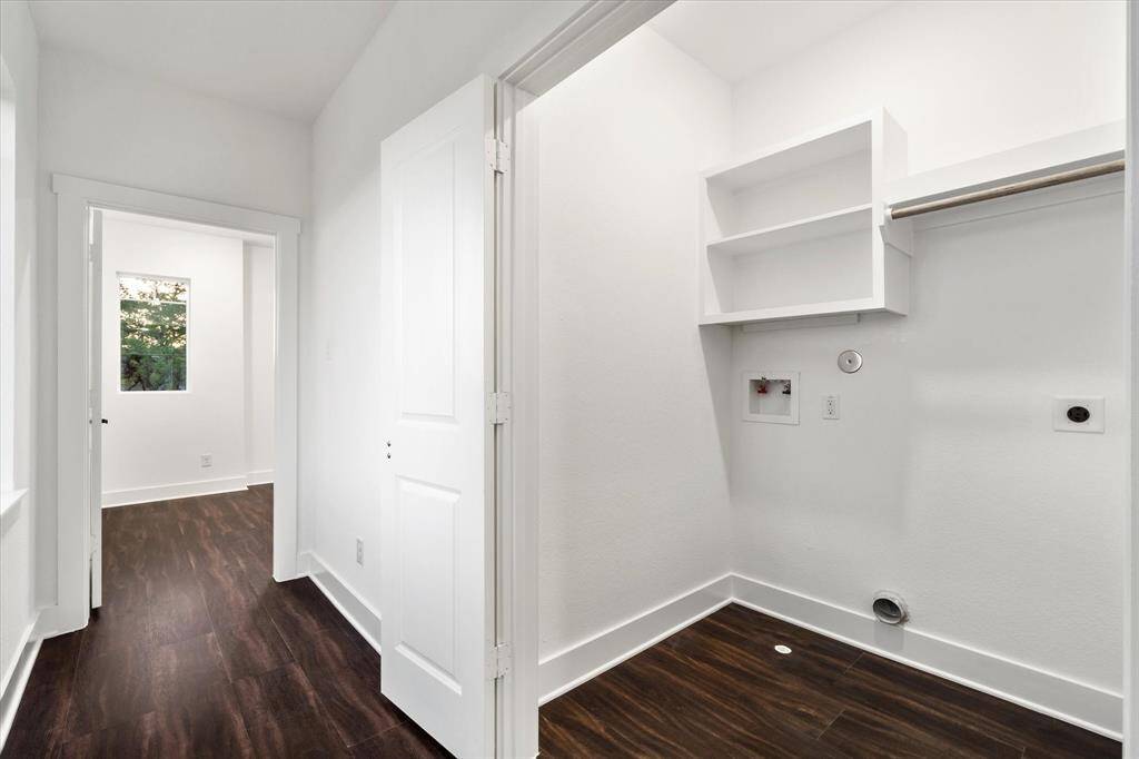 The laundry room is upstairs and comes fully equipped with storage and hanging space.