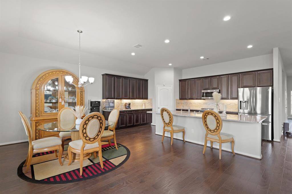 Granite countertops, undermount lighting, and an abundance of cabinetry offer storage and style.