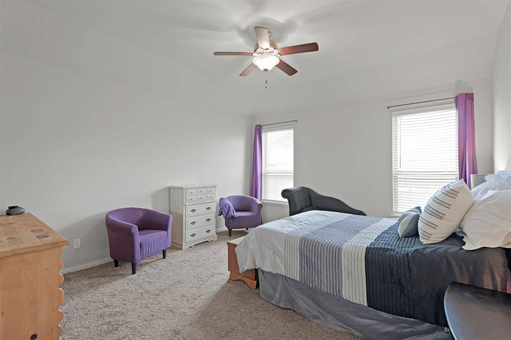 Tucked at the back of the home for added privacy, the spacious primary suite offers room to relax and recharge—with natural light pouring in from dual windows.