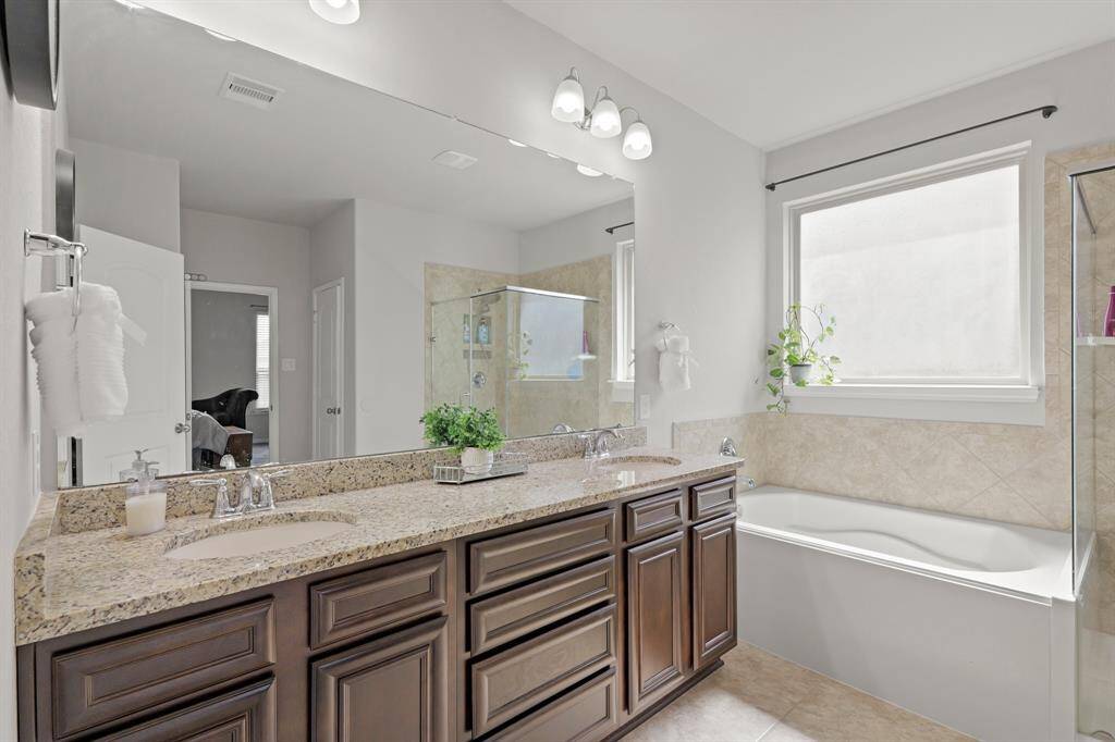 Dual sinks, granite counters, and loads of storage make mornings easier and evenings calmer.