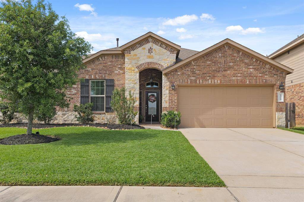 Charming elevation with upgraded stonework, custom shutters, and a manicured lawn that stays green year-round.
