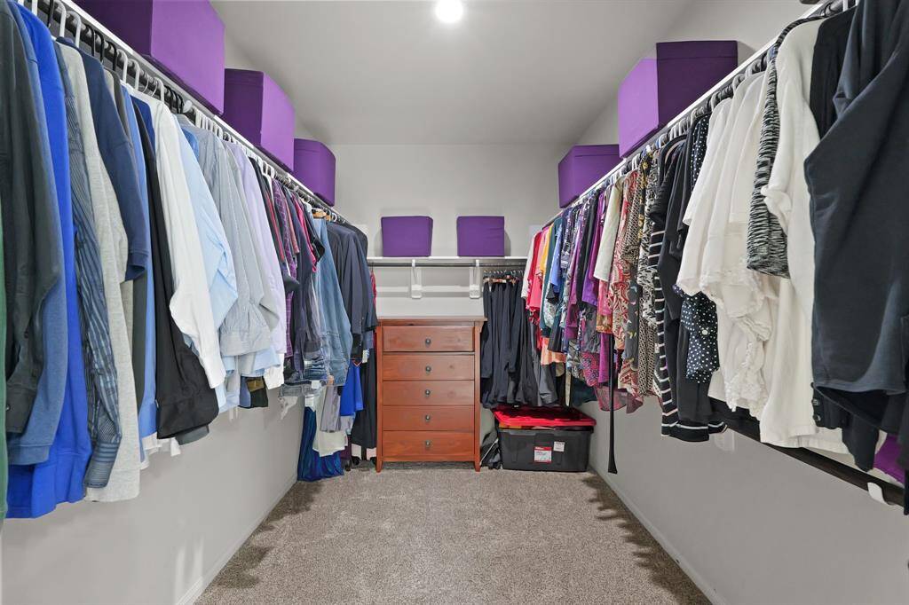 This massive walk-in closet offers double hanging space, built-in shelving, and tons of overhead storage—finally you will have room for everything (and then some).