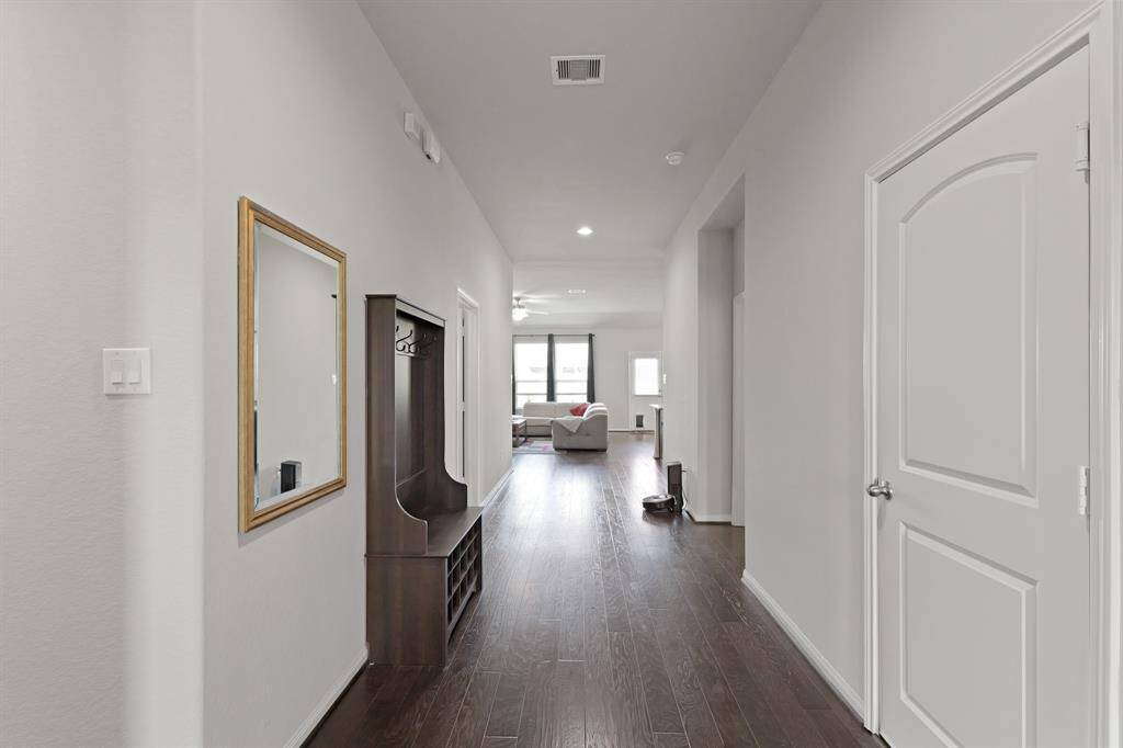 Step inside to a wide, welcoming entry that draws you straight into the heart of the home. Don’t miss the large opening on the right—just wait until you see the oversized flex space it leads to.