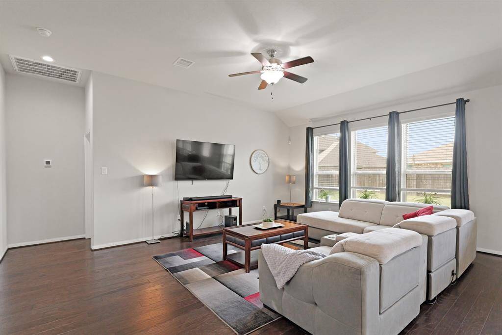 Generous living area with engineered hardwoods and plenty of room to gather and unwind.